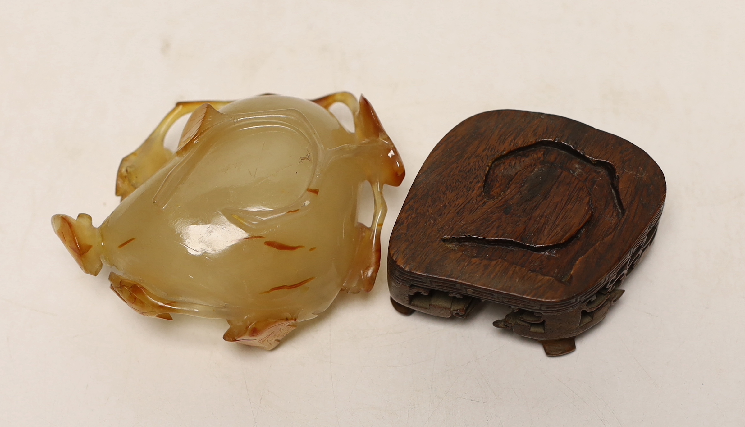 A Chinese agate brushwasher on carved stand, 8cms high including stand